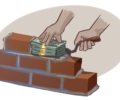 hands laying down bricks one brick is made of money