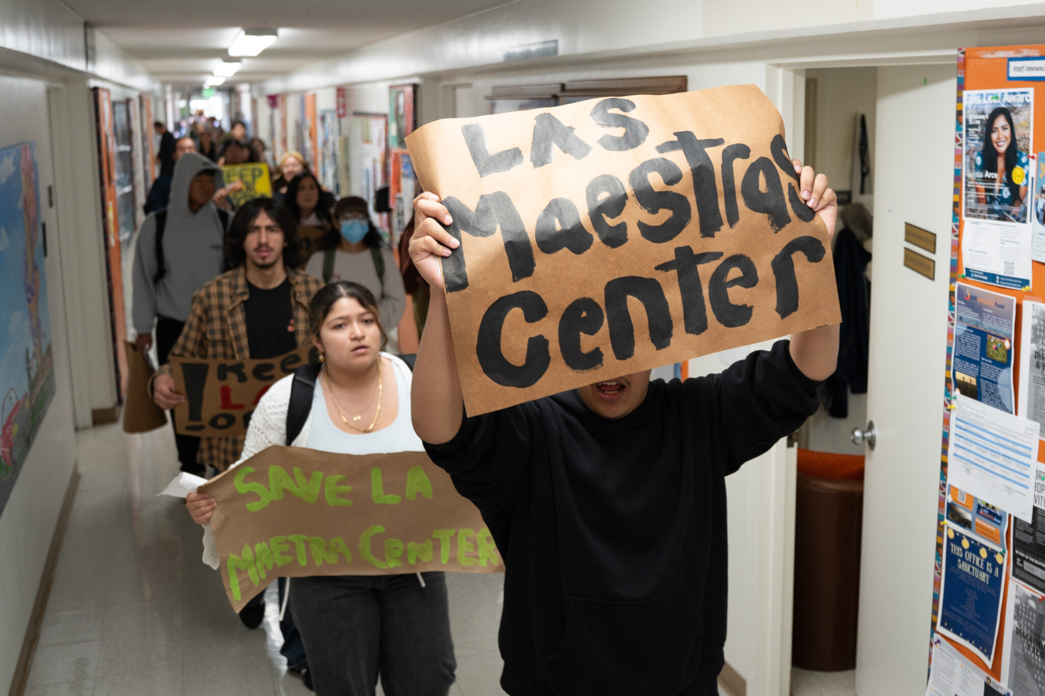 Protestors marched through South Hall in a single-file line chanting, banging on walls and putting up posters along the way. Shengyu Zhang / Daily Nexus
